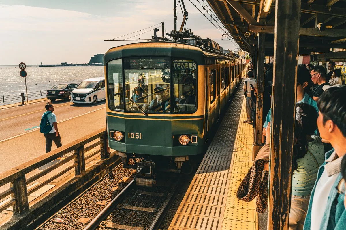 A local train arriving at a coastal station near Kamakura