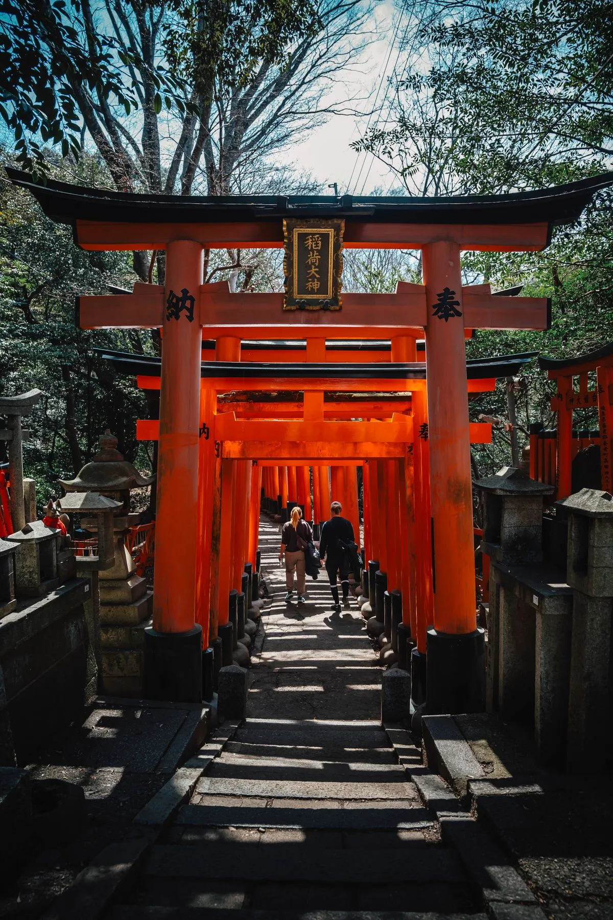 Visitors passing through the torii gates of Fushimi Inari Taisha, Kyoto